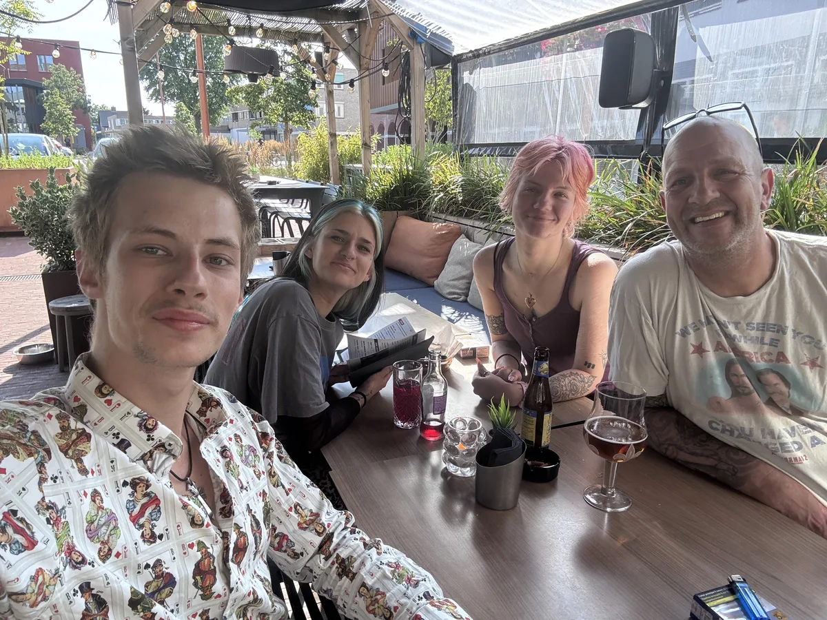 The four of them leaning into frame, second shot of the terrace selfie burst