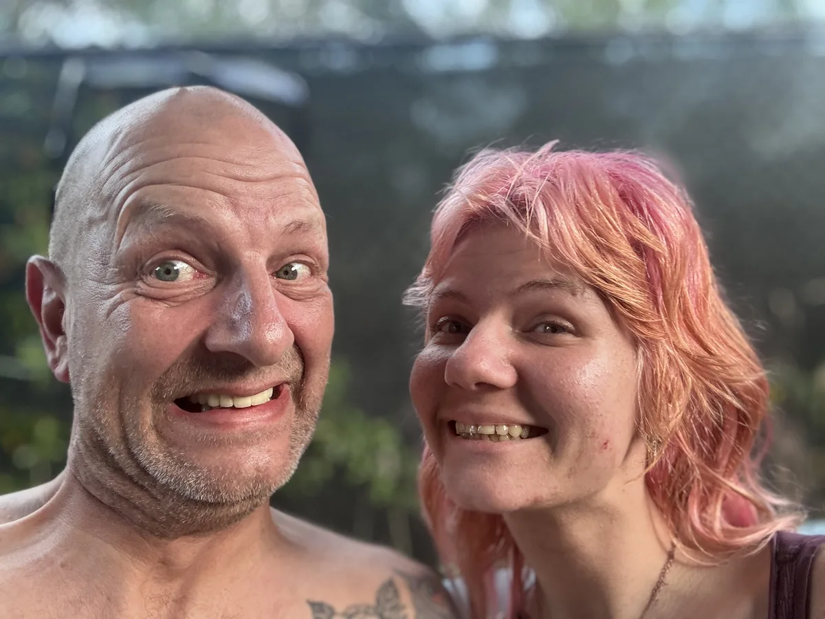 Sara and her father Richard in a hot tub, grinning at the camera in a close selfie