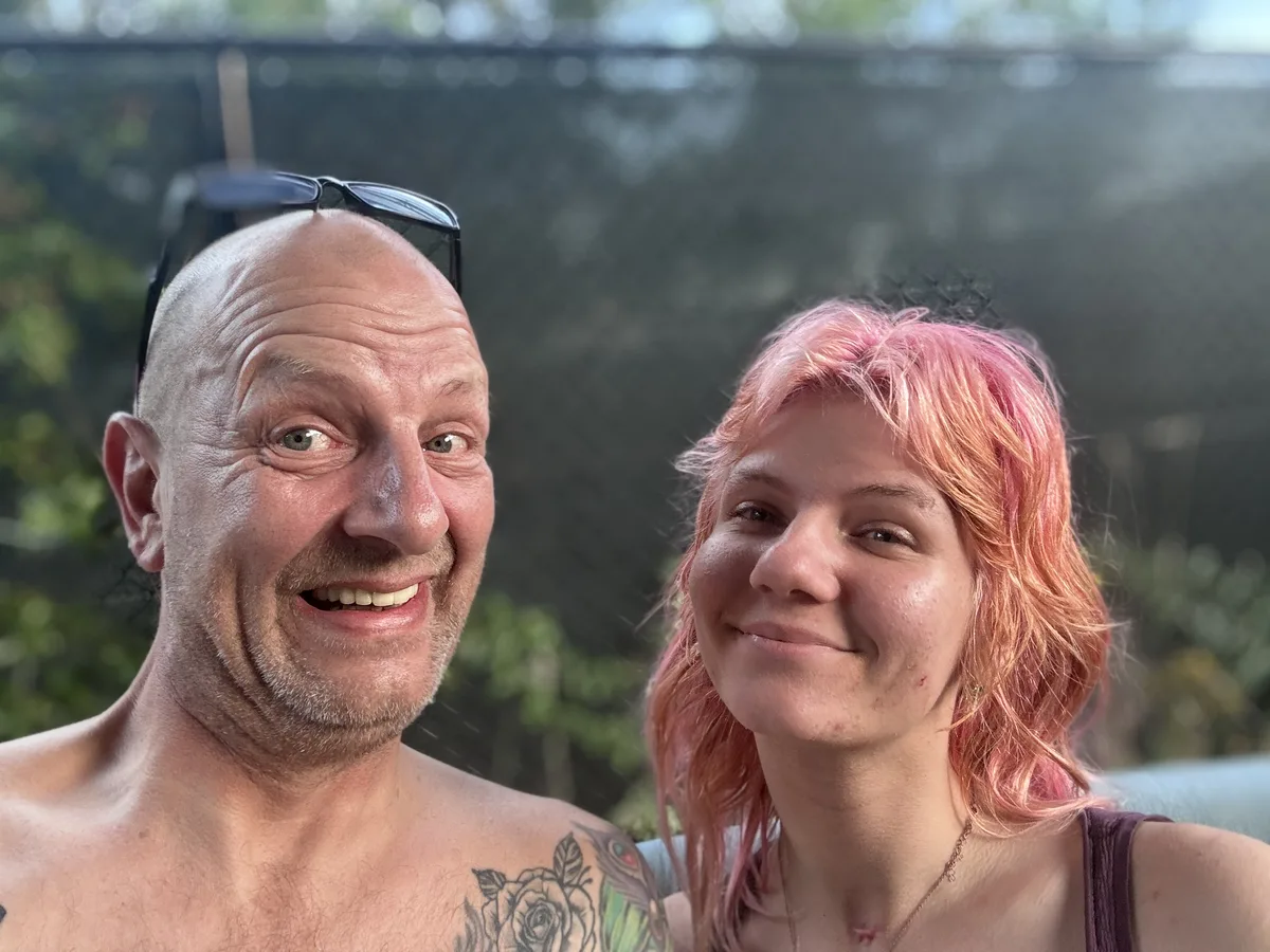 Sara and her father pulling playful faces, second frame of the selfie burst