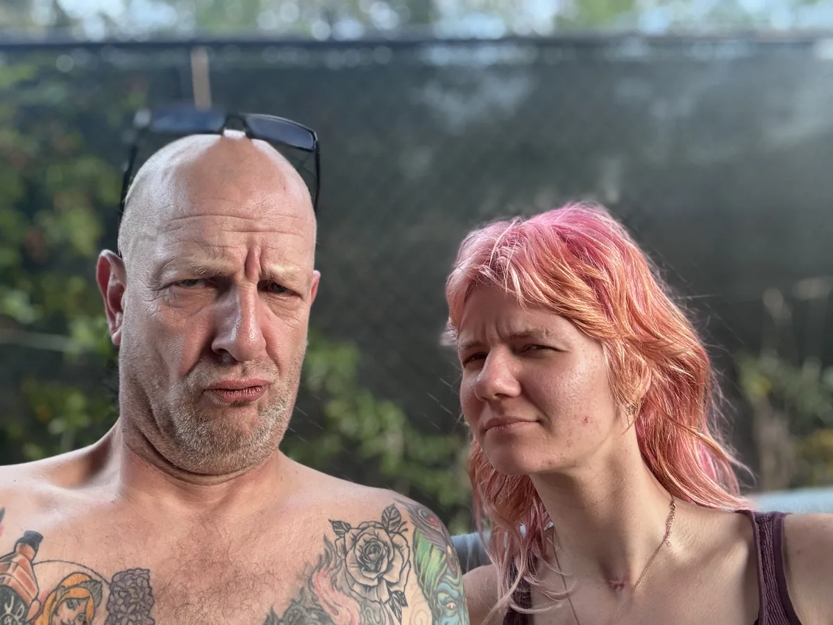 Sara laughing mid-burst while her father mugs for the camera